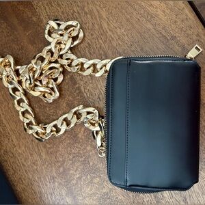 Anthropologie Black purse with heavy gold chain.